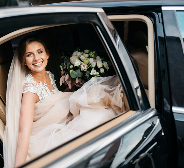 Bride sitting inside a luxury vehicle