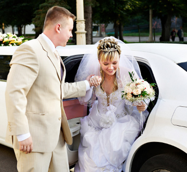 Bride stepping out of a limousine